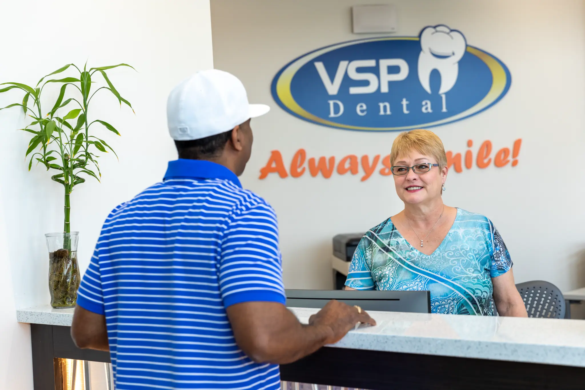 VSP Dental team member greeting a patient at the reception desk