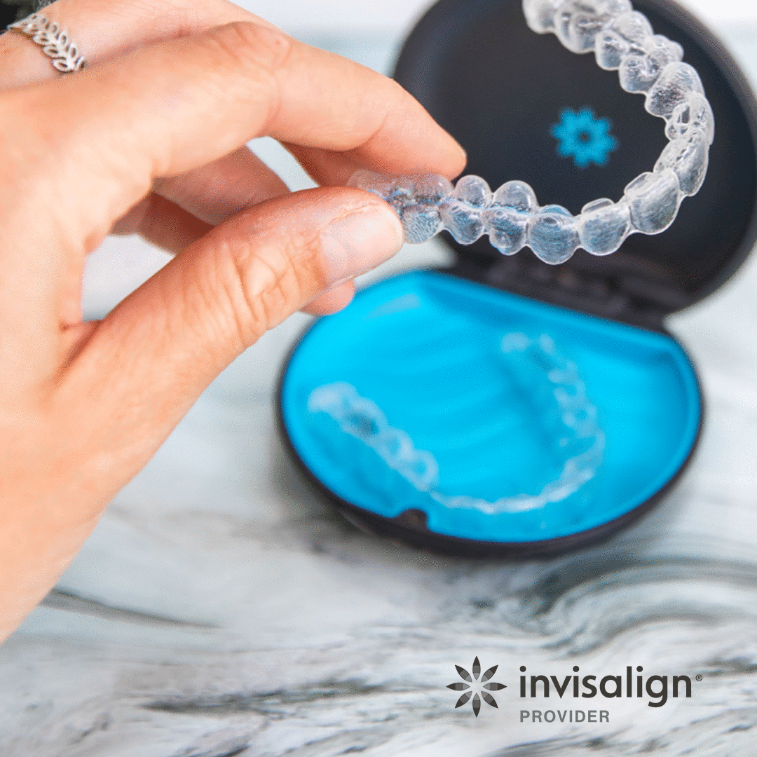 Clear Invisalign aligner held above its case