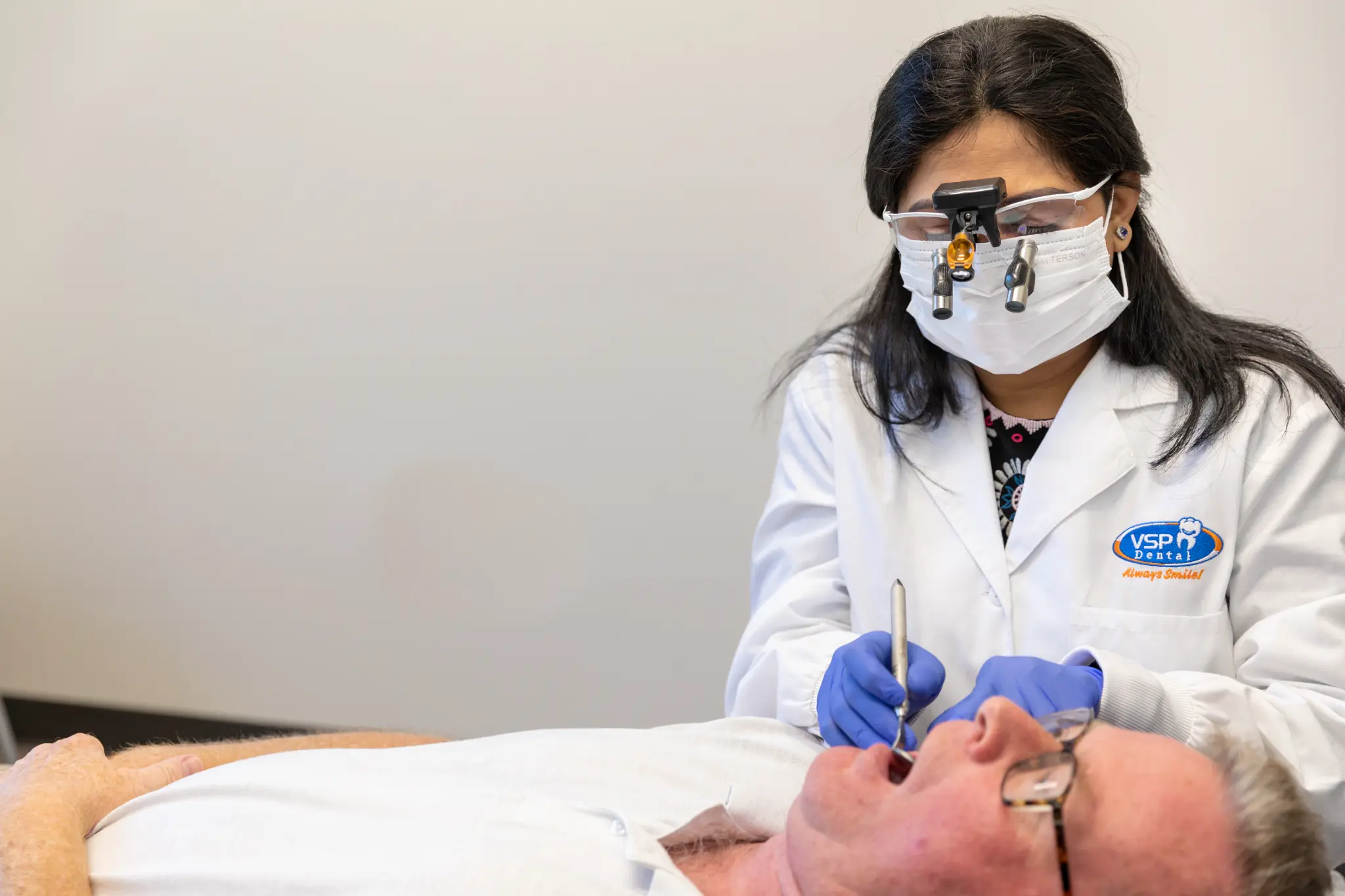 VSP Dental clinician providing periodontal care to a patient