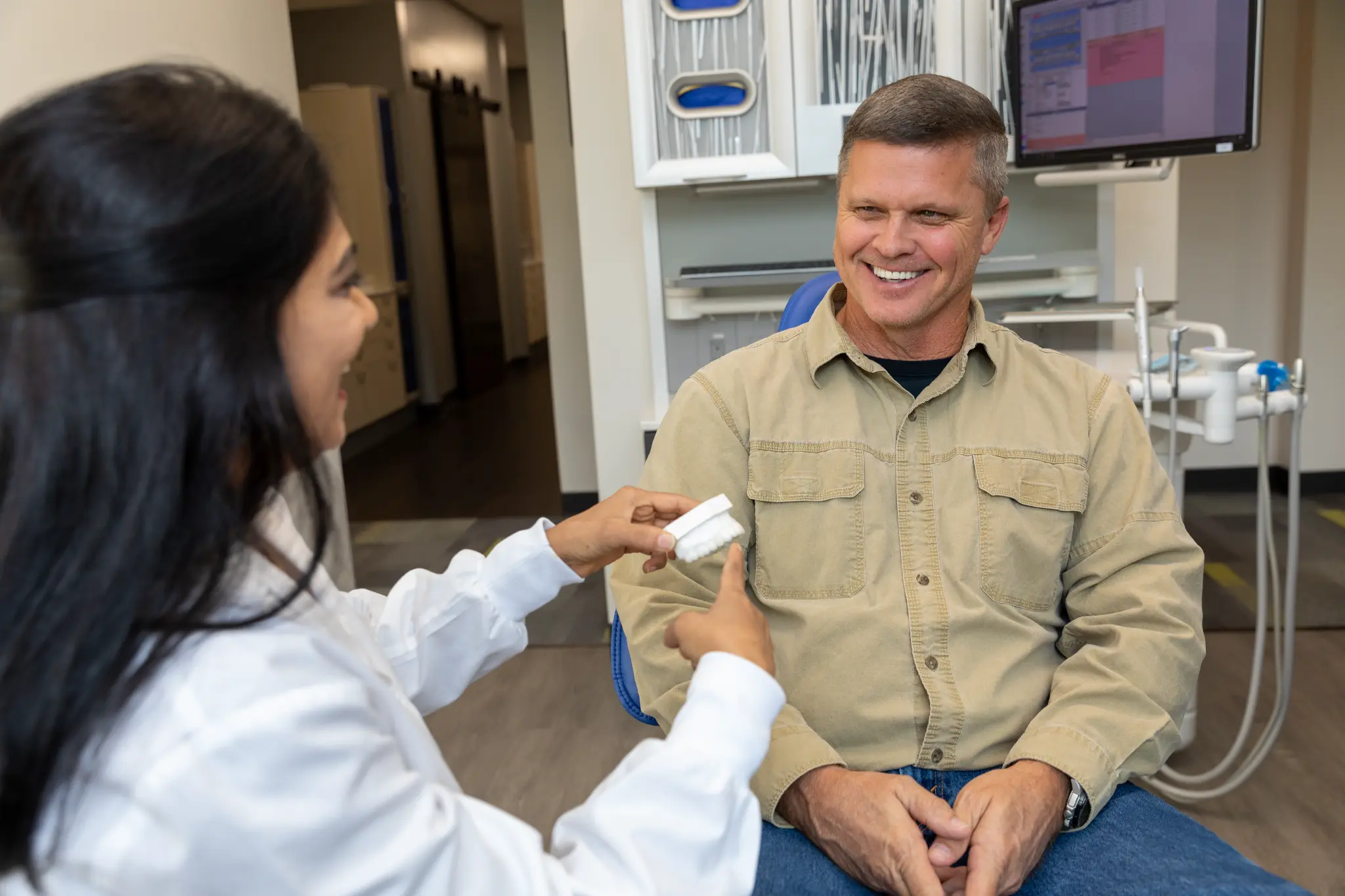 VSP Dental clinician reviewing restorative treatment options with a smiling patient