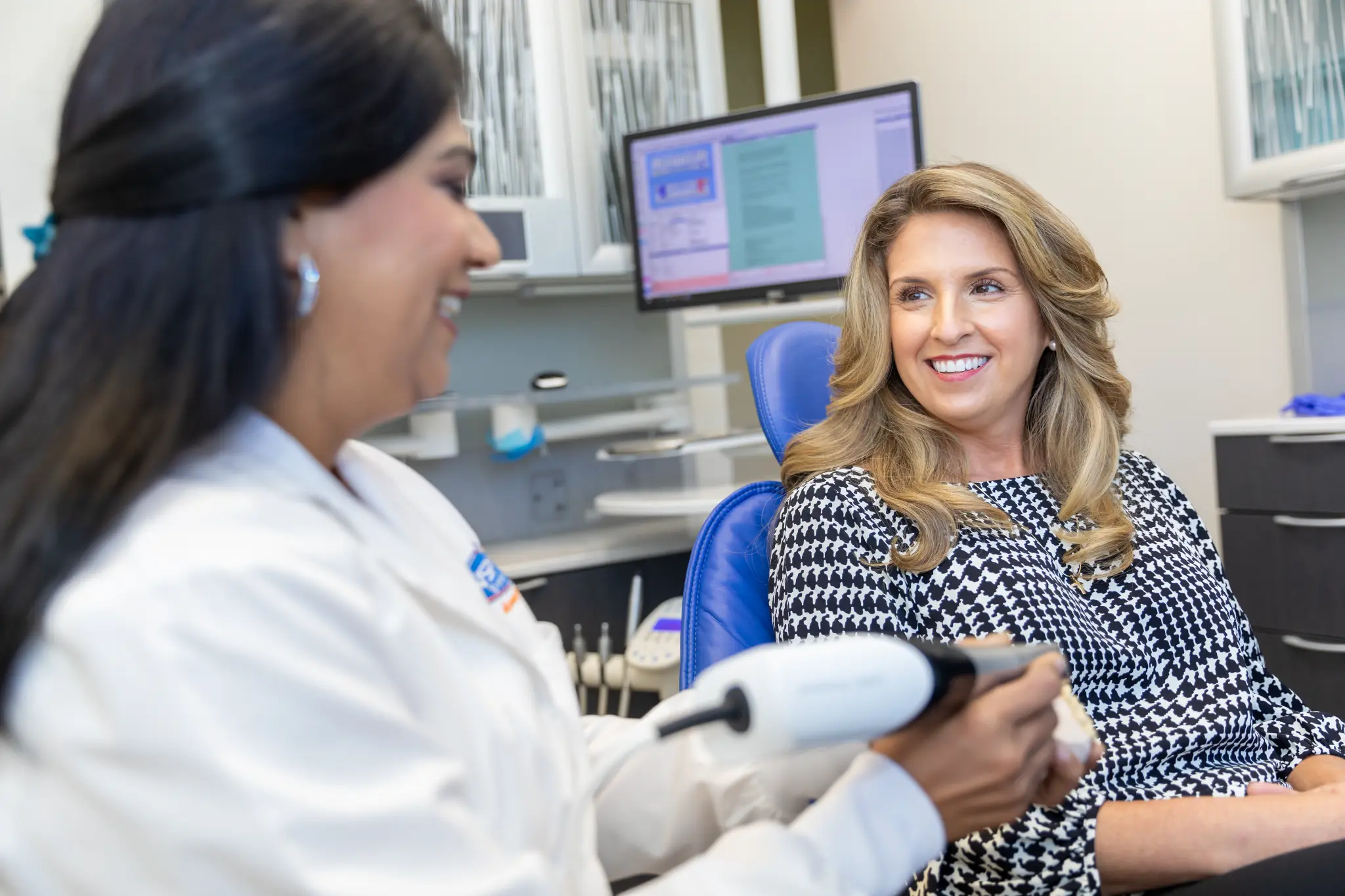 VSP Dental clinician speaking with a smiling patient during a cosmetic consultation