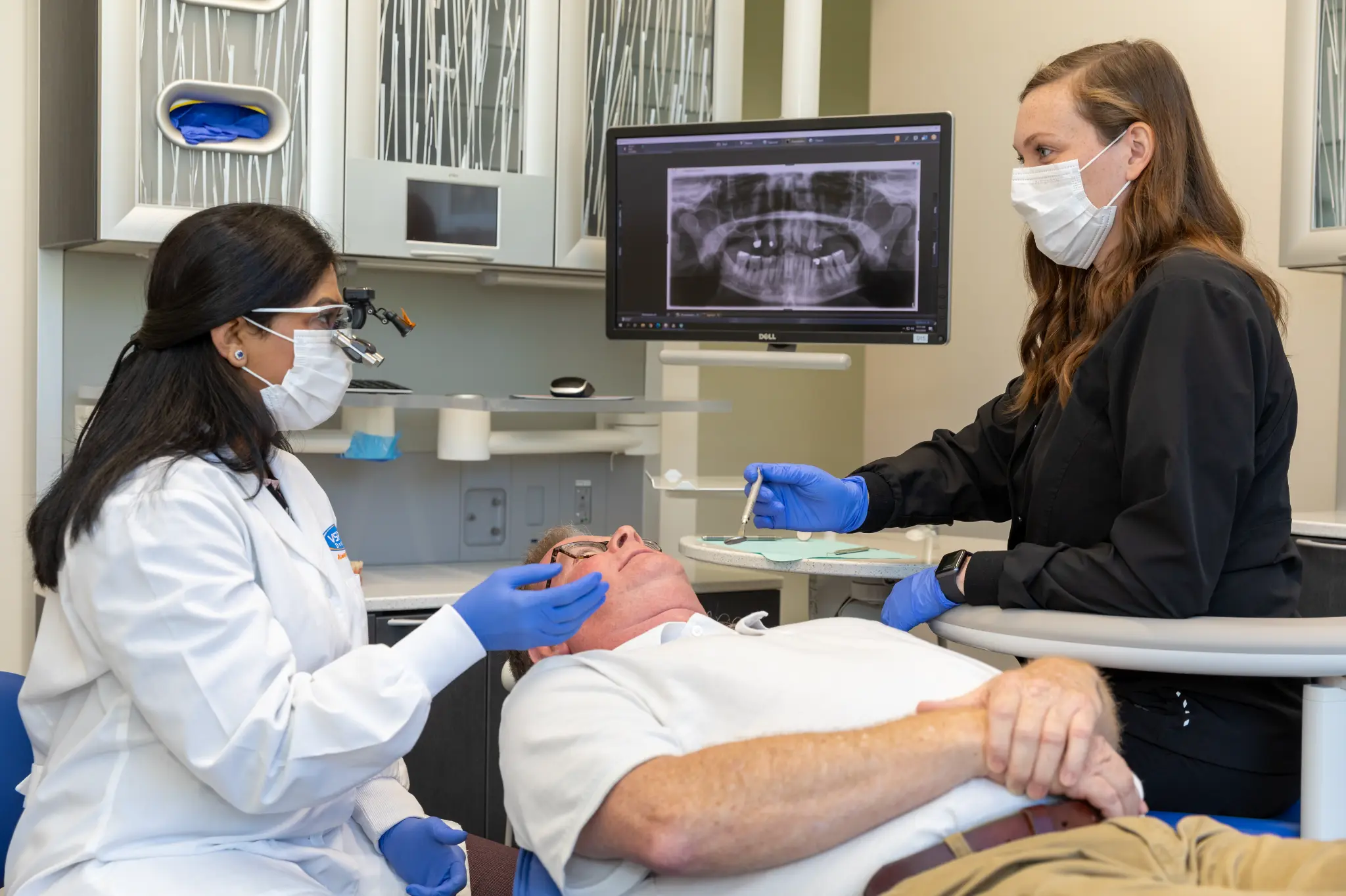 VSP Dental clinicians providing focused surgical care to a patient