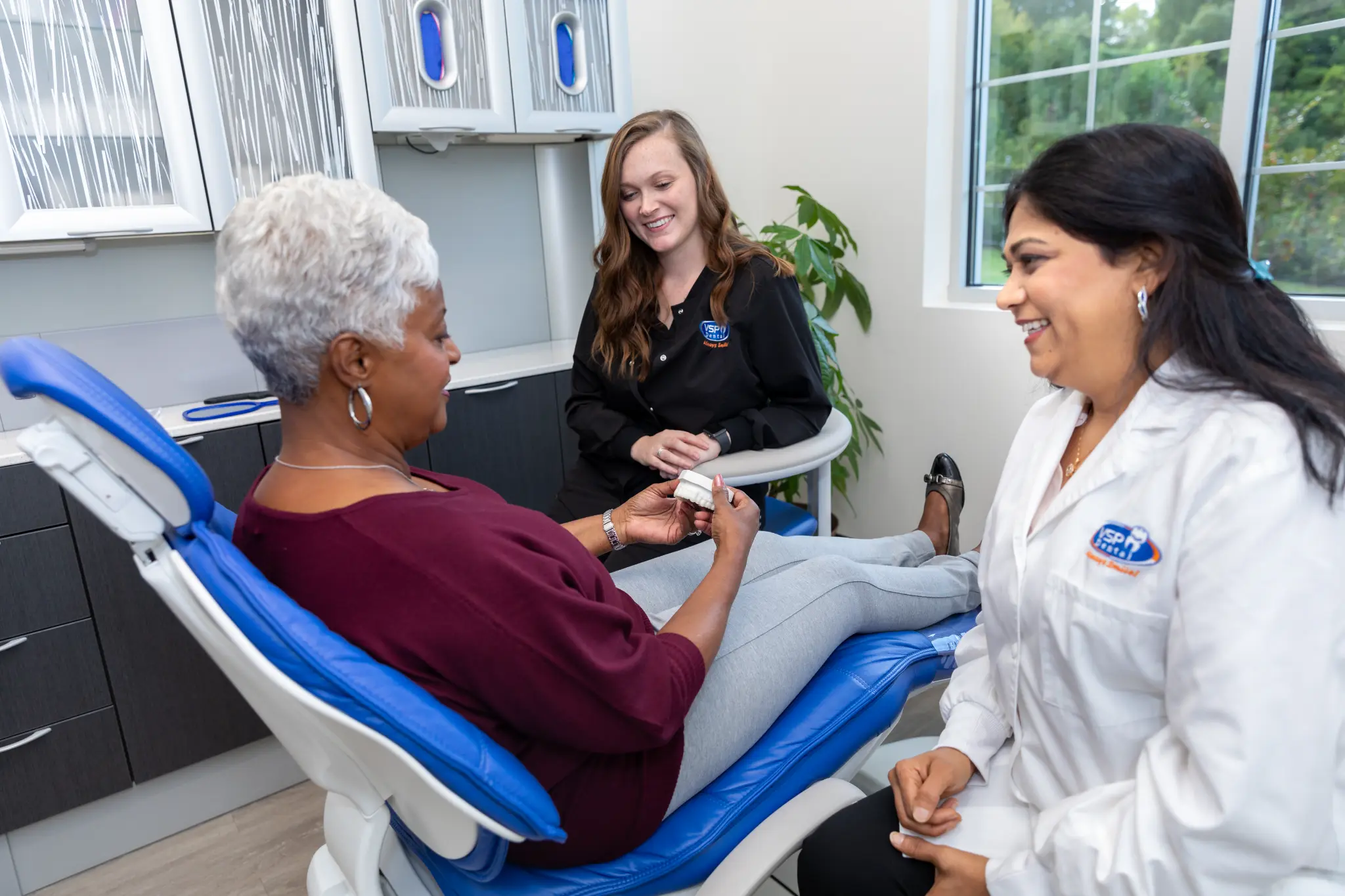 VSP Dental team speaking with a patient during a tooth-extraction consultation